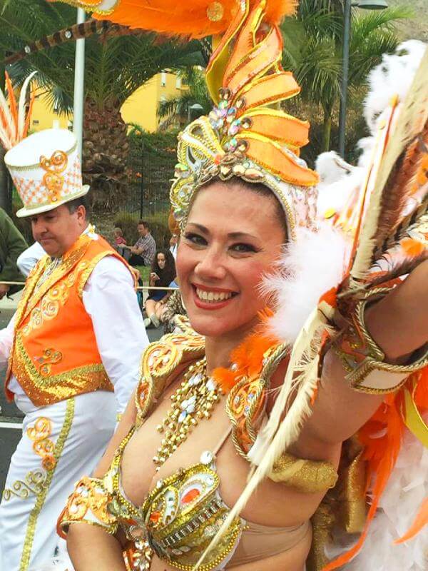 A radiant woman wearing a vibrant carnival costume, embodying joy, creativity, and cultural pride.