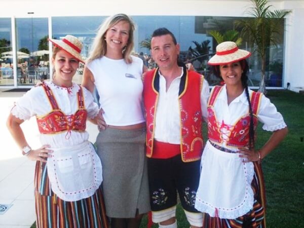 Iterns wearing traditional Canarian clothing while working at their hotel placement.