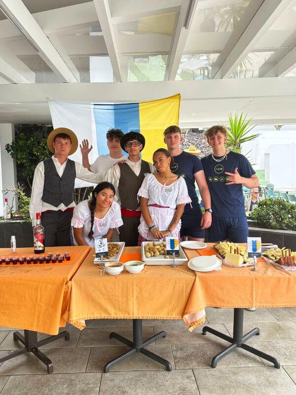 Traditional Canarian dishes served on a table with an intern enjoying local food during their stay in the Canary Islands.