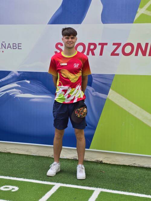 A young intern wearing athletic sportswear, standing confidently.