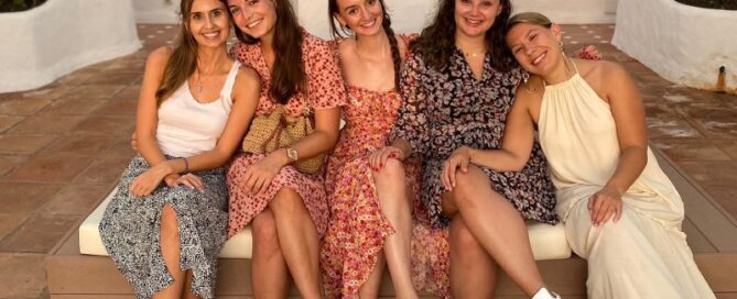 A group of friendly interns smiling and enjoying each other's company during their internship