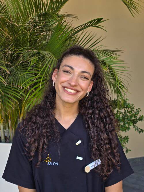Hotel spa intern standing with a friendly smile during her internship in the wellness department