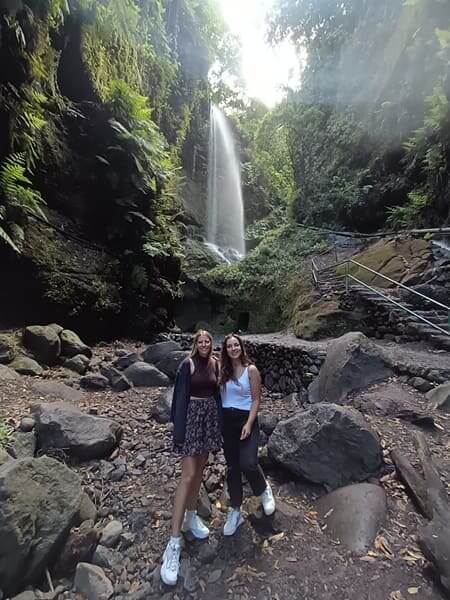 Cascada in La Palma during an internship in Spain Two interns posing in front of a waterfall in La Palma during their work placements in Spain